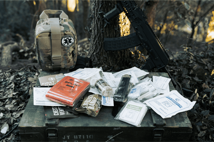 SE IFAK trauma kit with complete MARCH essentials laid out on a tactical surface for field readiness.